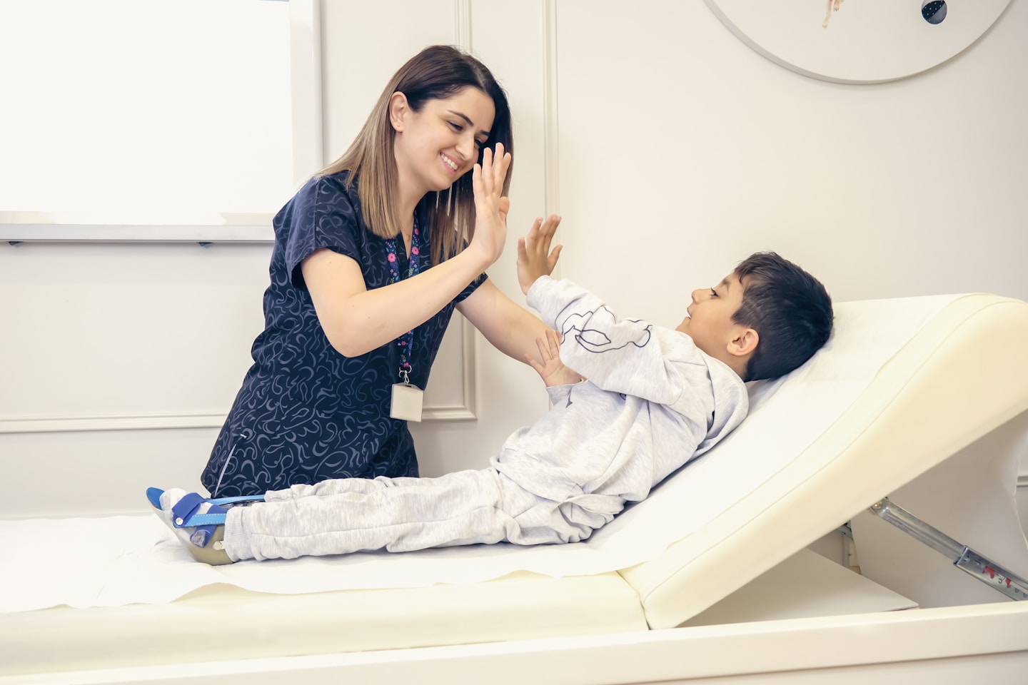 A child with osteogenesis imperfecta and a nurse together
